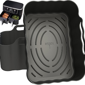May include: Black air fryer with two removable baskets and a black silicone storage container. The air fryer has a digital display and a timer. The storage container has a handle and the text "STOCK 1" printed on the bottom.