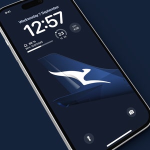 K&ouml;nnte beinhalten: Ein Smartphone-Bildschirm zeigt einen dunkelblauen Hintergrund mit einem wei&szlig;en K&auml;nguru-Logo. Die Uhrzeit ist 12:57 und das Datum ist Mittwoch, der 7. September. Der Akku ist zu 50% geladen und der Text "WH-1000XM5" ist sichtbar.