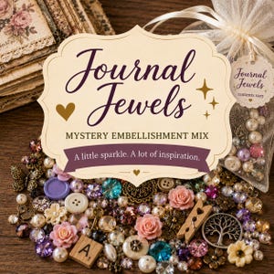 May include: A collection of craft embellishments including faux pearls, colorful rhinestones, miniature resin flowers, metal charms, and a wooden letter tile. A cream-colored label reads Journal Jewels, Mystery Embellishment Mix, A little sparkle. A lot of inspiration.