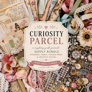May include: A craft supply bundle featuring a central label reading CURIOSITY PARCEL, a mystery junk journal supply bundle, ephemera, fabric, vintage paper, and creative extras. The collection includes lace, ribbons, buttons, and floral accents.