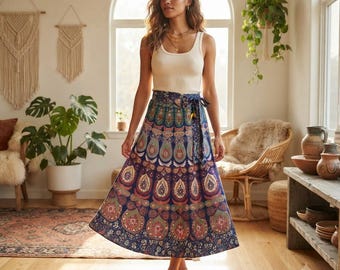 May include: A cream-colored ribbed tank top paired with a long, high-waisted wrap skirt featuring a vibrant, multi-colored mandala and paisley print in shades of deep blue, orange, and green, secured with a matching fabric tie at the waist.