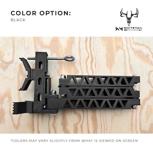 May include: Black hunting blind stand with a triangular design and a metal clamp. The stand is made of durable plastic and is designed to be lightweight and portable.