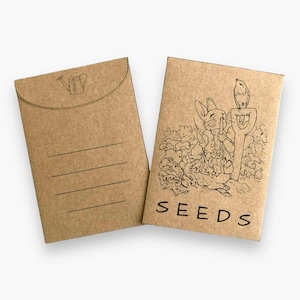 May include: A brown paper envelope with a flap on the top. The envelope has a watering can icon on the front and the word "SEEDS" printed on the back. The back of the envelope also features a black and white illustration of a rabbit holding a carrot and a bird perched on a shovel.
