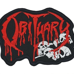 May include: Embroidered patch with the word "OBITUARY" in red, dripping letters on a black background. White skulls are below the text, with red dripping accents. The patch has a black border.