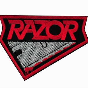 May include: Red and black embroidered patch with the word "RAZOR" in red lettering and a stylized razor blade with a red drip.
