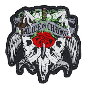 May include: Embroidered patch featuring the words "ALICE IN CHAINS" on a banner, with a red rose pierced by a dagger. The design includes two skulls, a ram skull, wings, and figures, all on a black background.
