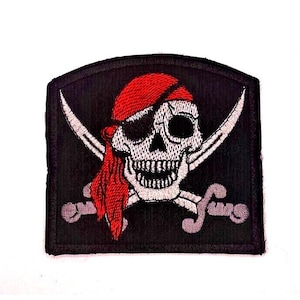 May include: Embroidered patch featuring a pirate skull with a red bandana and eye patch. Two crossed swords are behind the skull on a black background. The patch is rectangular with a curved top.