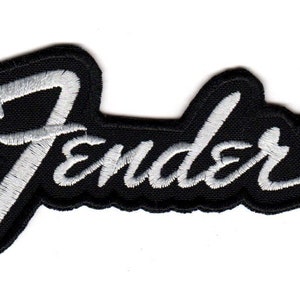 May include: Black and white embroidered patch with the word "Fender" in a stylised script font. The patch has a registered trademark symbol.