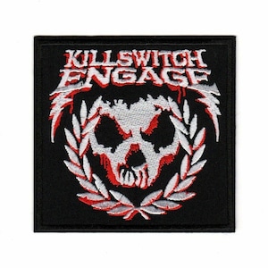 May include: Black embroidered patch featuring the band name "Killswitch Engage" in white lettering and a white skull with red accents surrounded by a white laurel wreath.