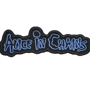 May include: Embroidered patch with the words "Alice in Chains" in light blue on a black background. The patch has a black border and a stylized font. Suitable for jackets, bags, or other fabric items.