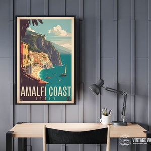 May include: A vintage travel poster with a colorful illustration of the Amalfi Coast in Italy. The poster features a view of the coastline with buildings, a beach, and boats in the water. The text on the poster reads "Amalfi Coast, Italy".