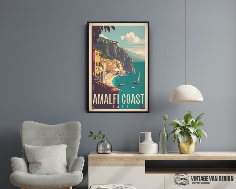 May include: A vintage travel poster featuring a colorful illustration of the Amalfi Coast in Italy. The poster has a blue background with a white sailboat and a view of the coastline with buildings and cliffs. The text on the poster reads "Amalfi Coast, Italy".