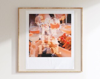 May include: A framed print featuring a group of hands holding cocktail glasses. The image has a vintage aesthetic, with the words "So I For The Plot" overlaid on the image. The drinks appear to be various shades of orange and pink.