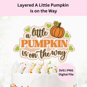 May include: A cake topper with the text "a little PUMPKIN is on the way" in orange and black script, with a pumpkin graphic. The topper is on a white cake with white frosting and colorful sprinkles. The text "Layered A Little Pumpkin is on the Way" is at the top.
