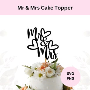 以下が含まれることがあります： 黒と白のケーキトッパーで、「Mr & Mrs」という文字が筆記体で書かれています。トッパーは、白と桃色の花で飾られた白いケーキの上に置かれています。