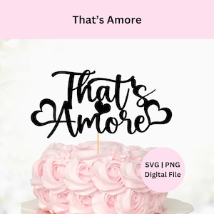 May include: A black cake topper with the words "That's Amore" in a cursive font, with heart accents. The topper is placed on a pink frosted cake. The image also includes the text "SVG | PNG Digital File".