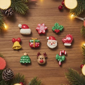 May include: A collection of ten small Christmas-themed resin buttons featuring a Santa hat, a red snowflake, holly leaves, a yellow bell, a green gift box, a Santa Claus face, a red mitten, a green tree, a reindeer, and a candy cane.