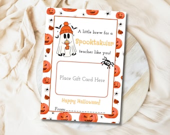 May include: A printable gift card template featuring a cute ghost holding a pumpkin spice latte. The template has a Halloween theme with orange and black pumpkins, spiders and bats. The text reads "A little brew for a Spooktakular teacher like you!" and "Place Gift Card Here".