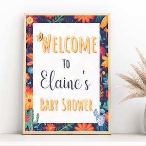 May include: A welcome sign for a baby shower with a colorful floral border and the text "Welcome to Elaine's Baby Shower".
