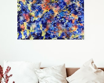 May include: Abstract painting with a blue background and colorful, swirling patterns. The painting is framed and hanging on a white wall.