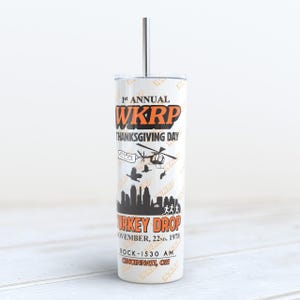 May include: White tumbler with a black and orange design featuring the text "1st Annual WKRP Thanksgiving Day Turkey Drop November, 22nd, 1978 Rock-1530 AM Cincinnati, OH".