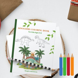 May include: A black and white coloring book with a green border. The cover features a dinosaur with a volcano and palm trees. The title is "Dinosaurs Coloring Book" and the subtitle is "For Kids Ages 4-8". The book is by "Margid's Adventures".
