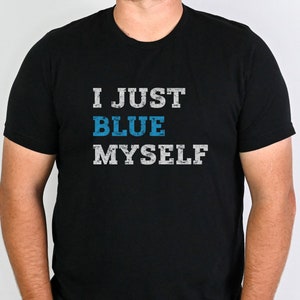 May include: A black t-shirt with the text "I JUST BLUE MYSELF" in white and blue lettering.