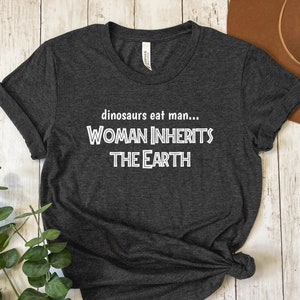 Woman Inherits the Earth Shirt | Movie Quote Shirt | Funny T-Shirt | Film Lover Gift | Fan Tee | Movie Lover T-Shirt | Dinosaurs Eat Man