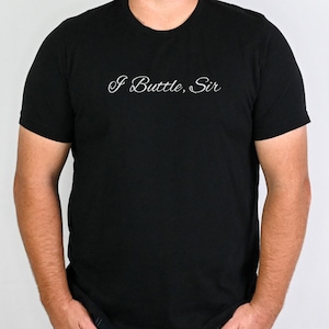 May include: A black t-shirt with the text "I Buttle, Sir" in white cursive lettering.