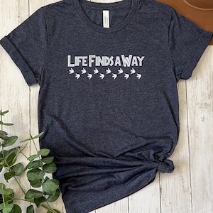 Life Finds a Way Shirt | Movie Quote T-Shirt | Funny Film Fan Gift | T-Rex | 90s Nostalgia Top | Steven Spielberg | Dinosaurs | Velociraptor