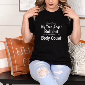 May include: Black t-shirt with white text that reads "Dear Diary, My Teen Angst Bullshit now has a Body Count".
