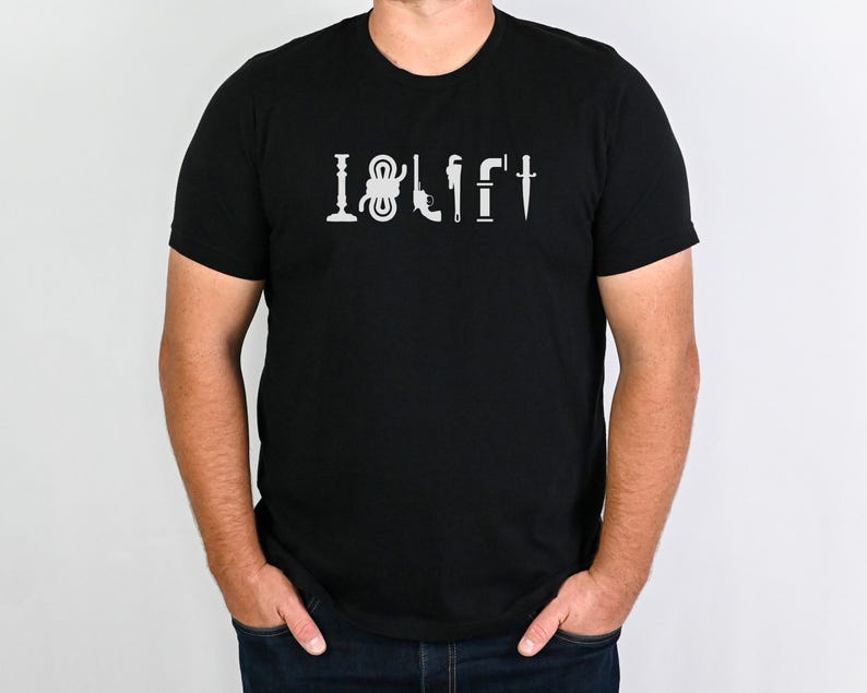 May include: A black t-shirt with a white graphic that says "I &hearts; LIFT" with a series of tools, including a wrench, a hammer, a screwdriver, and a pipe.