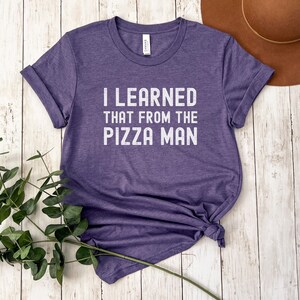 May include: A purple t-shirt with the text "I LEARNED THAT FROM THE PIZZA MAN" printed in white.