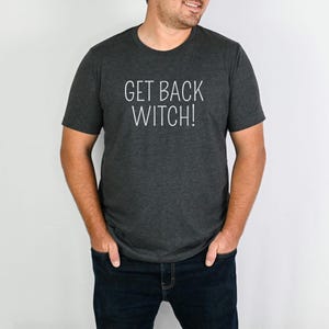 May include: A dark gray t-shirt with the text "GET BACK WITCH!" printed in white.