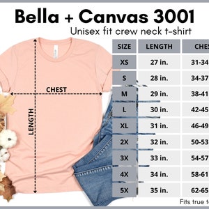 May include: A peach-colored unisex t-shirt with a crew neck and short sleeves. The t-shirt is laid flat on a white surface with a pair of blue jeans and fall leaves. A size chart is shown with measurements in inches for chest and length.