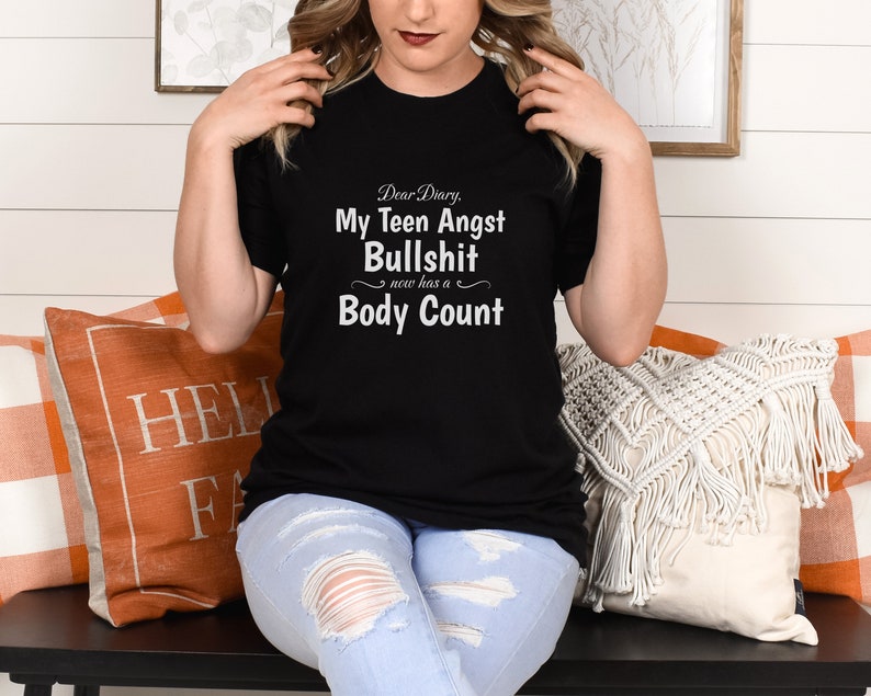 May include: Black t-shirt with white text that reads "Dear Diary, My Teen Angst Bullshit now has a Body Count".