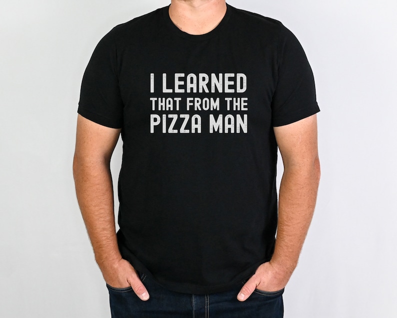 May include: A black t-shirt with the text "I LEARNED THAT FROM THE PIZZA MAN" printed in white.