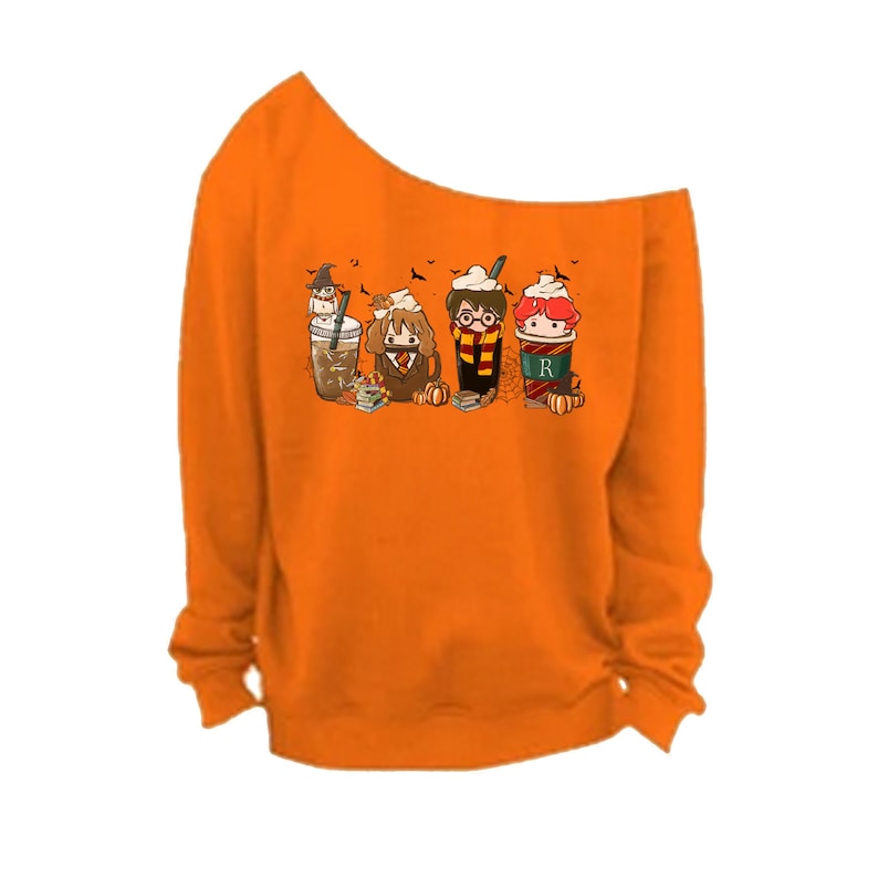 May include: Orange off-the-shoulder sweatshirt with a graphic of Harry Potter, Ron Weasley, and Hermione Granger characters as fall-themed drinks. The characters are wearing their Hogwarts house scarves.