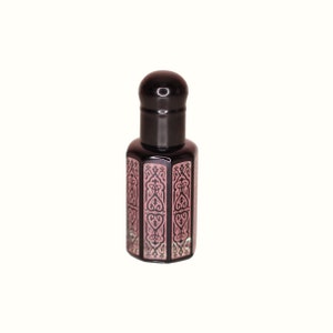 May include: A small, dark brown glass bottle with a black cap and intricate black and pink designs. The bottle is filled with a clear liquid.