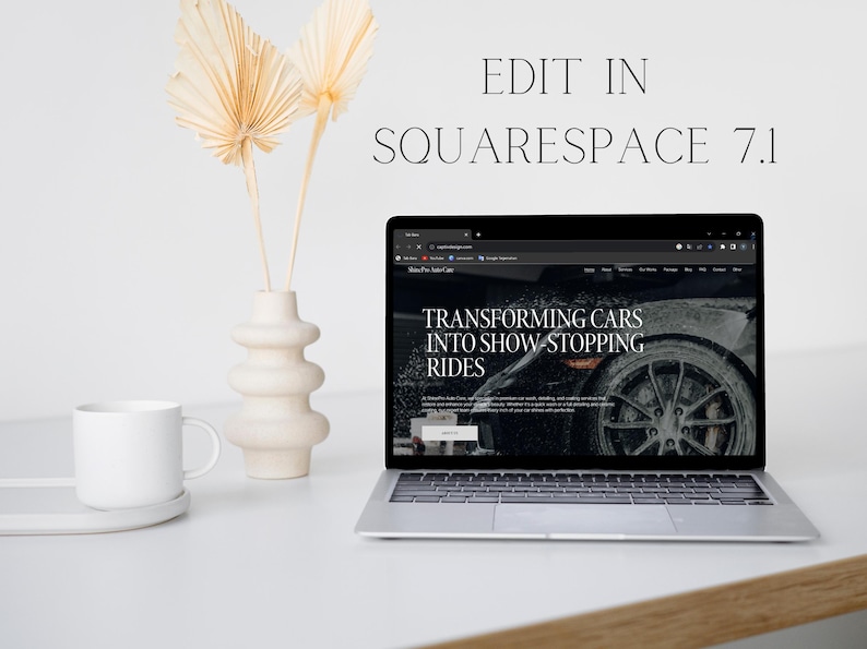 May include: A laptop computer displaying a website with the text "Transforming Cars into Show Stopping Rides" on a white desk with a white mug and a vase with dried palm leaves.