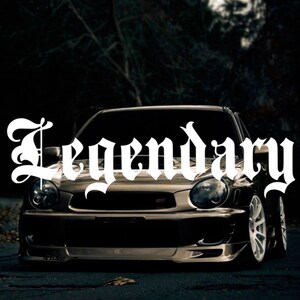May include: A dark gray car with the word "Legendary" in white gothic lettering on the front windshield.