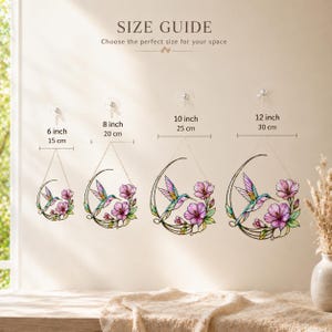 May include: A size guide graphic displaying four stained glass hummingbird and flower suncatchers in crescent moon frames. Sizes labeled are 6 inch, 8 inch, 10 inch, and 12 inch. Each piece features a colorful hummingbird and pink flowers.
