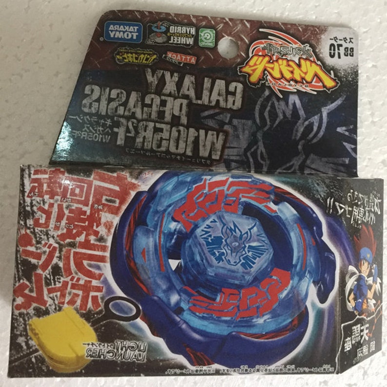 May include: A blue and red Galaxy Pegasus toy with a light launcher and packaging. The packaging features Japanese text and the words "GALAXY PEGASUS W105R2F". The toy is a hybrid wheel attack type.