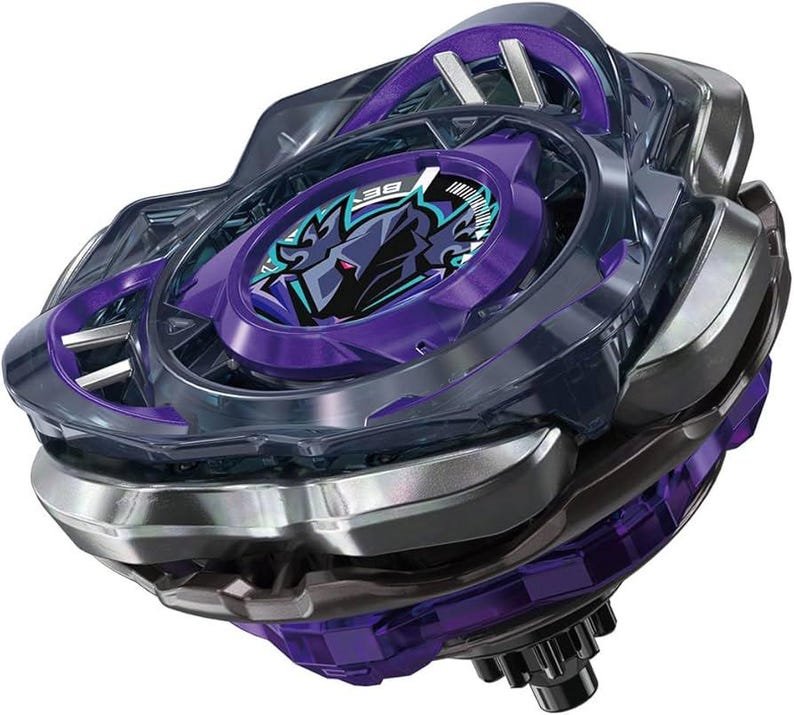 May include: A purple and silver spinning top toy with a detailed design. The toy features a central purple disc with a graphic and the text "BE". The outer ring is silver and the top has a clear plastic casing.