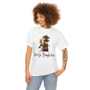 May include: White t-shirt with a cartoon illustration of a woman in a green dress and hat holding a beer mug. The text "Erin Go Bragh-less" is printed below the illustration.