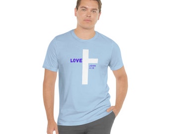 Puede incluir: Una camiseta azul claro con una cruz blanca y las palabras "LOVE" y "JOHN 3:16" en morado.