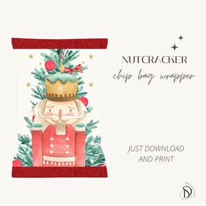 May include: Printable chip bag wrapper featuring a watercolor illustration of a nutcracker standing in front of a Christmas tree with red ornaments and gold stars. The text "NUTCRACKER chip bag wrapper" is printed in black at the top of the image.