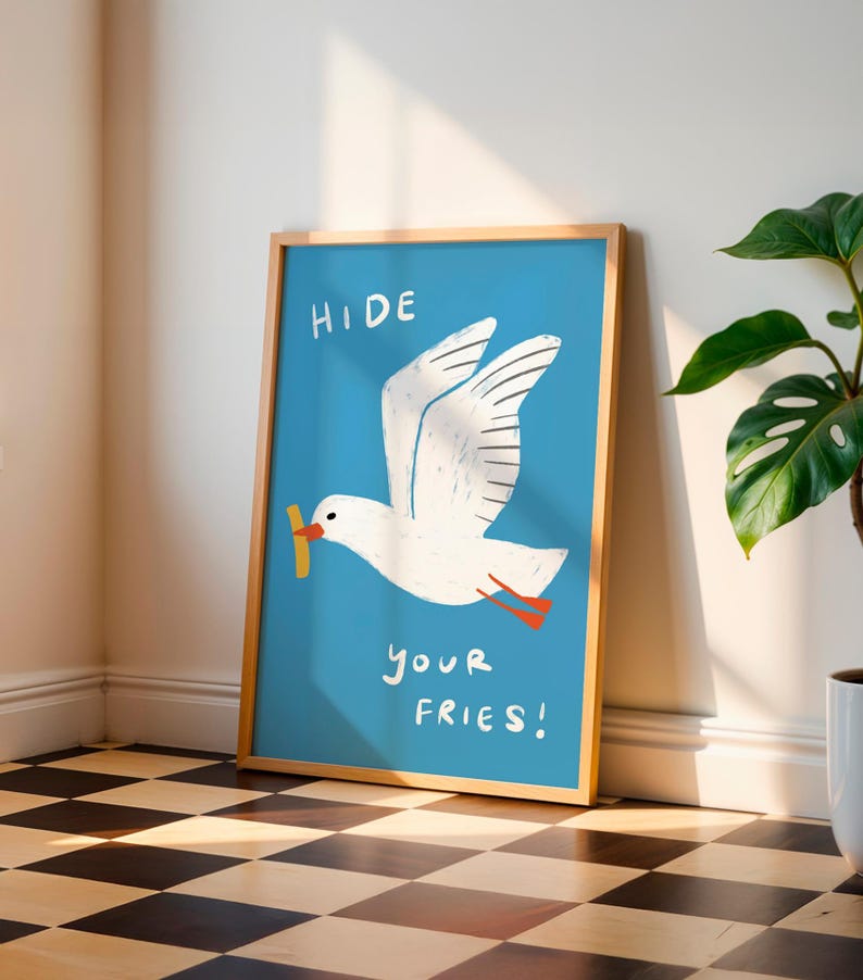 A cheeky seagull eyes a pile of fries in this vibrant, maximalist illustration, bursting with bold colors and playful text warning to protect your snacks. Perfect for adding a humorous coastal vibe to kitchens, beach house nooks, or sunny living spaces. Quirky vacation art, funny home accent, dopamine decor gift, coastal wall hanging, playful beachy print. Ideal for fry-loving friends or anyone craving a lighthearted, maximalist touch to their decor. Frame it for a pop of joy in any room.