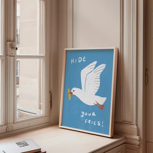 A cheeky seagull eyes a pile of fries in this vibrant, maximalist illustration, bursting with bold colors and playful text warning to protect your snacks. Perfect for adding a humorous coastal vibe to kitchens, beach house nooks, or sunny living spaces. Quirky vacation art, funny home accent, dopamine decor gift, coastal wall hanging, playful beachy print. Ideal for fry-loving friends or anyone craving a lighthearted, maximalist touch to their decor. Frame it for a pop of joy in any room.