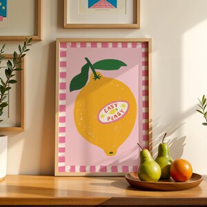 Cheerful hand drawn lemon illustration with playful easy peasy typography, bright yellow citrus fruit wall art in dopamine art style, modern kitchen print with quirky lettering and fun fruit doodles, maximalist summer decor featuring bold colors and happy vibes, trendy food art perfect for kitchen gallery wall, retro inspired fruit illustration with positive message, funky home decor with fresh citrus theme